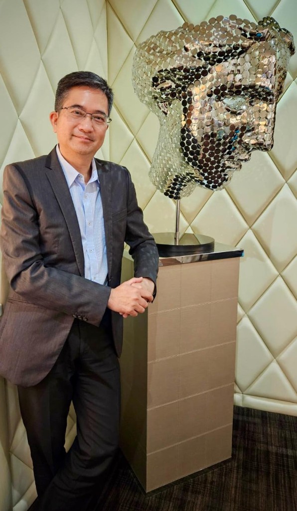 Dr. David Tan in a tailored suit at the clinic, professional aesthetic medicine portrait.